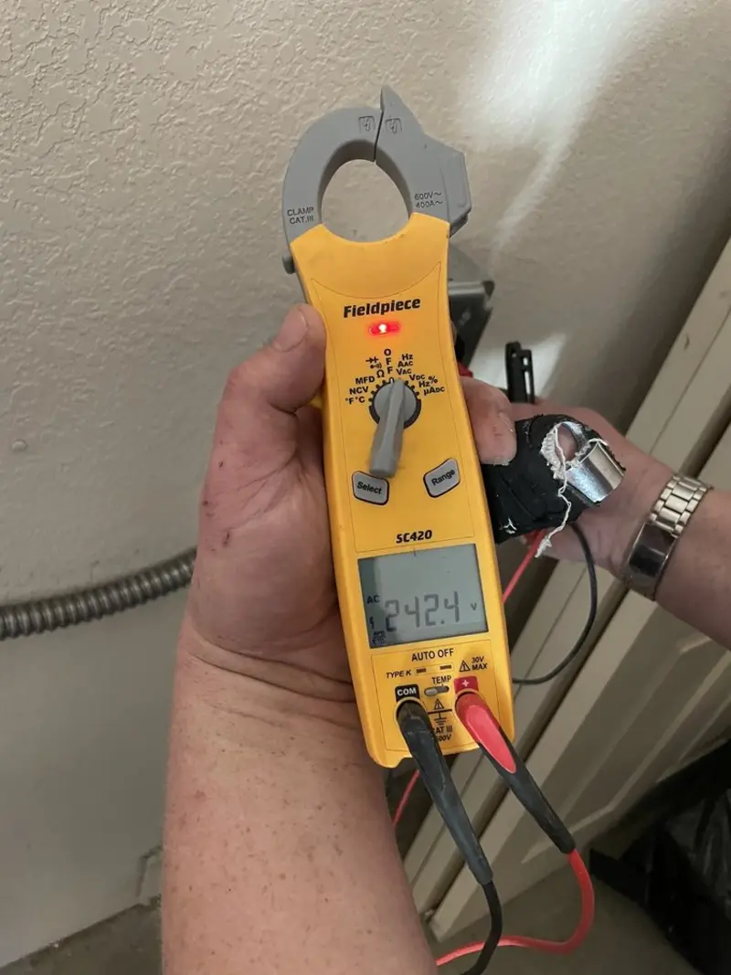 Voltage testing with clamp meter during Recessed Lighting Installation in Lynnfield